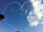 Red Arrows making a heart over the house